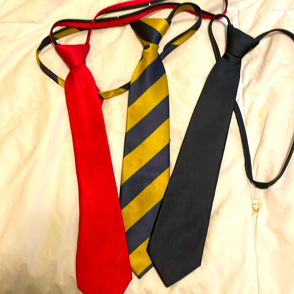 Boys tie collection. Three in all. Black, red and gold navy stripes. Pre tied.